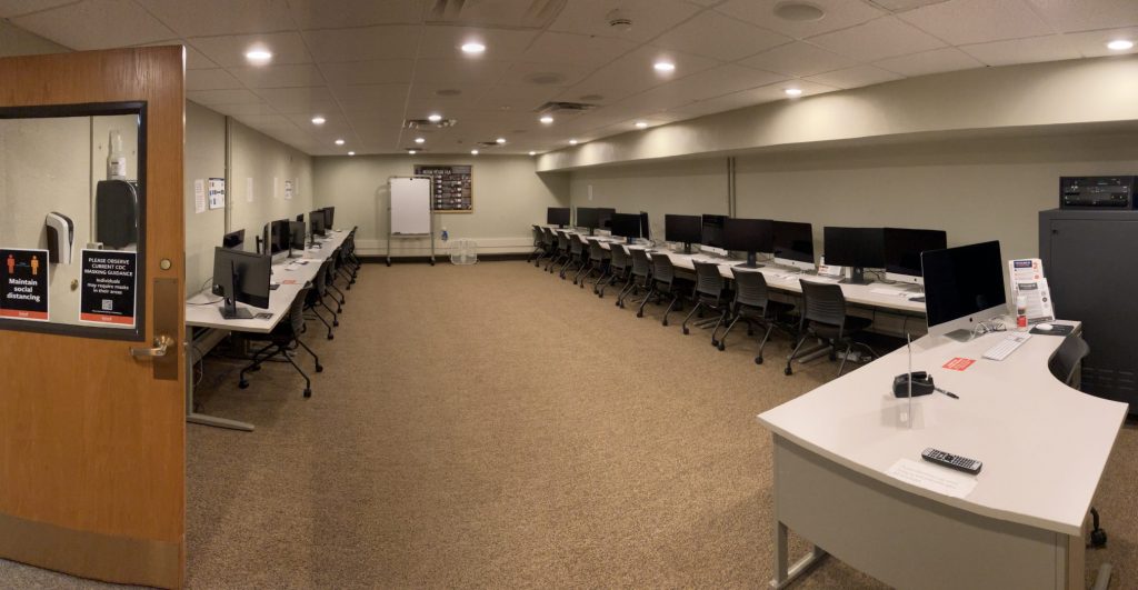 An empty computer lab with two rows of computers