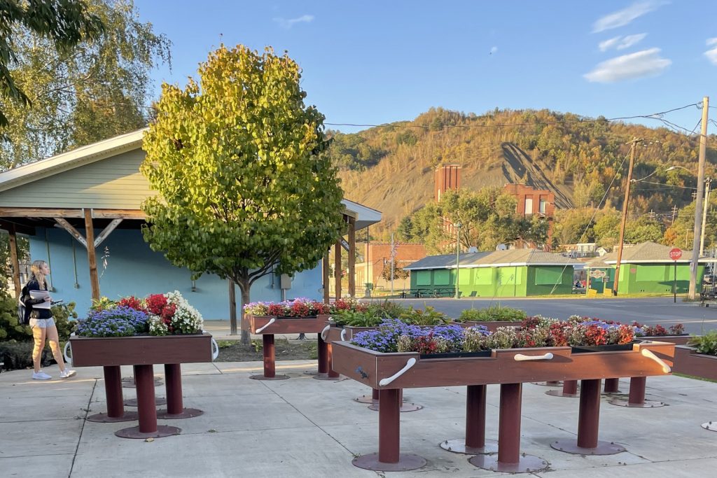 Garden boxes sit in the city square, nestled below the mountain of coal mine tailings.